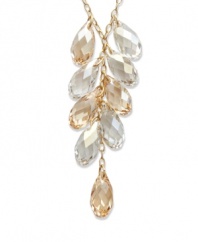 A sparkling array in rich tones will set your look off for an evening of ambiance. Swarovski's glistening gold tone mixed metal pendant elegantly combines Crystal Golden Shadow and clear crystal accents. Approximate length: 15 inches. Approximate drop: 2 inches.